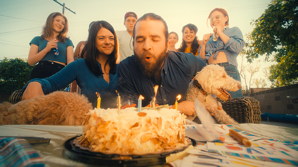 Shane Brady and an ensemble cast celebrate in BREATHING HAPPY (2022)